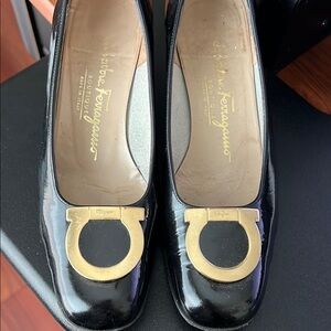 Salvatore Ferragamo Black and Gold Flats with Classic Design